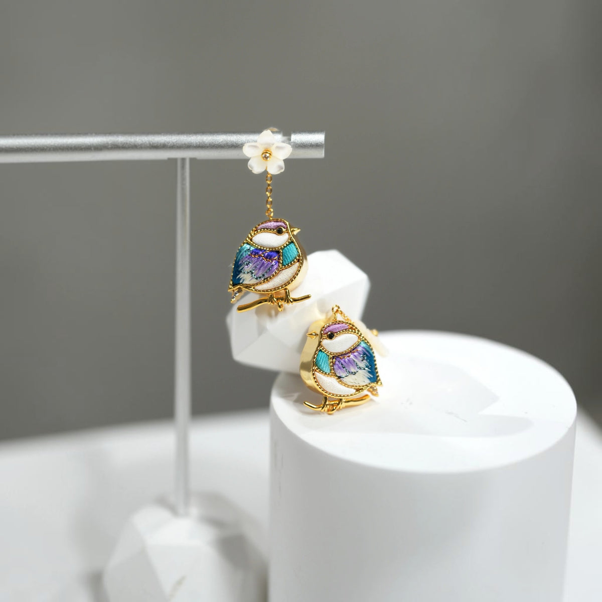 Detail view of purple magpie Su-embroidery drop earrings