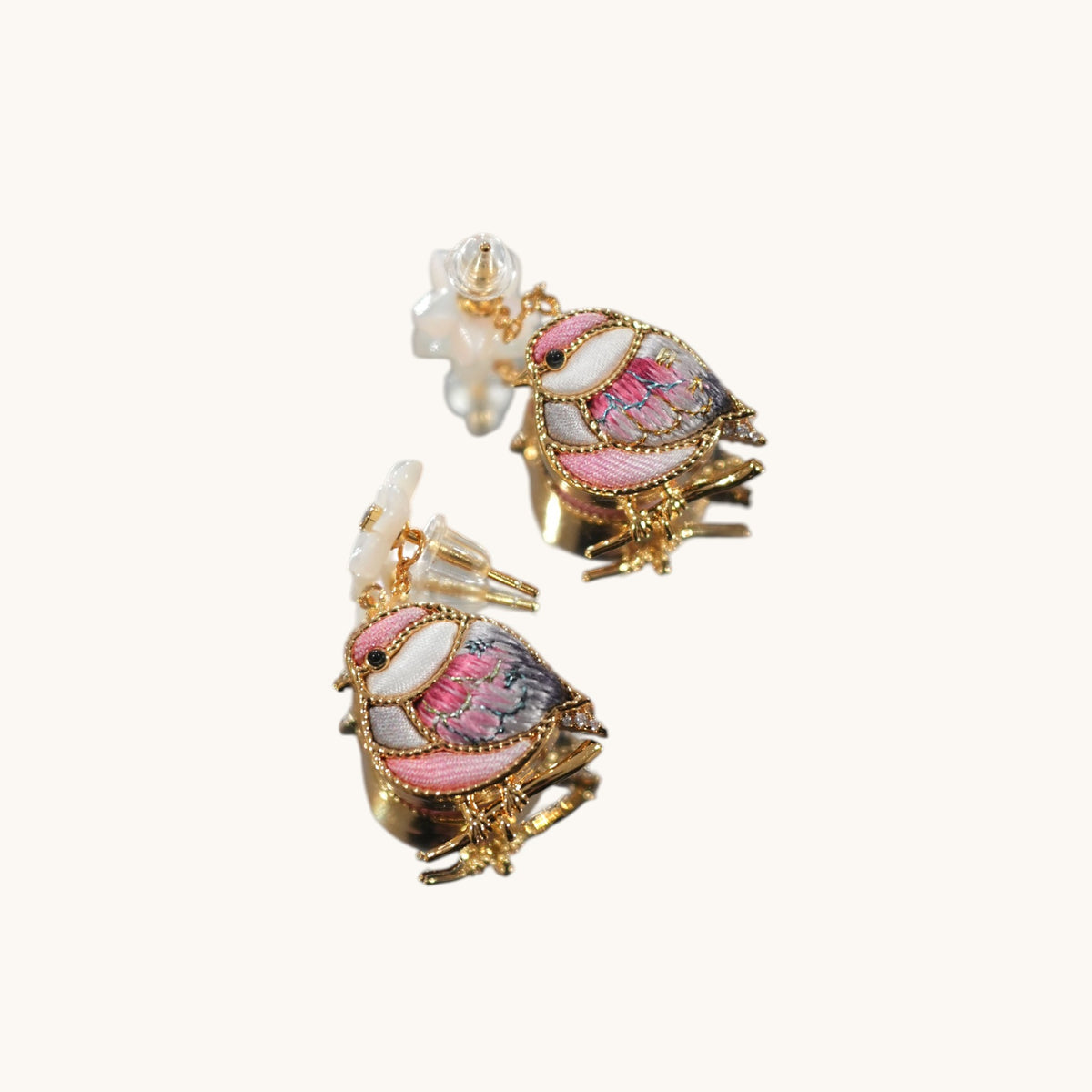Detail view of red magpie Su-embroidery drop earrings